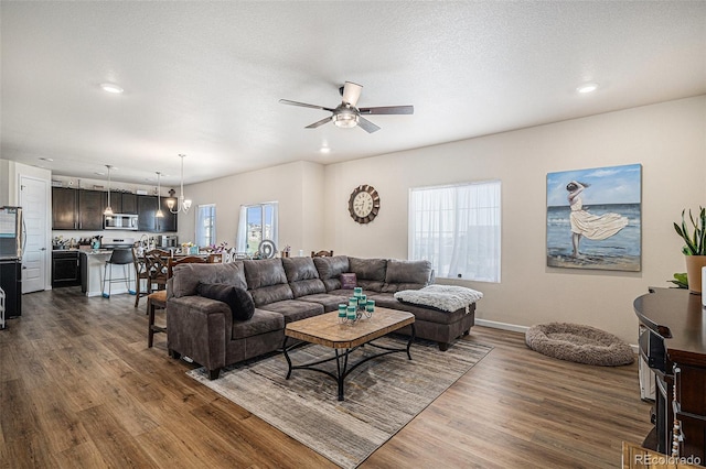 living area with plenty of natural light, a ceiling fan, dark wood-style floors, and recessed lighting