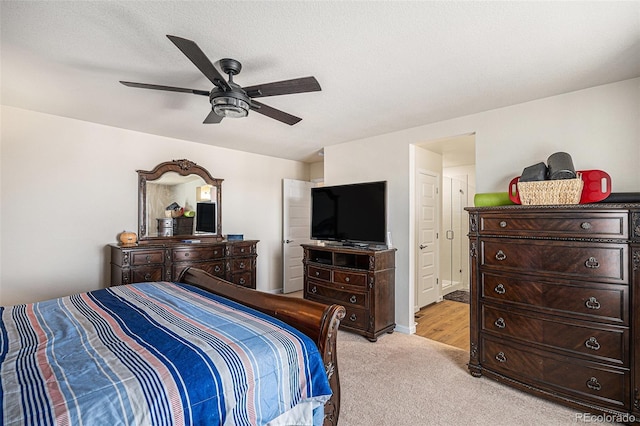 bedroom with ceiling fan and light carpet