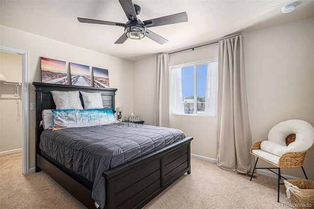 bedroom featuring a ceiling fan, baseboards, and light carpet