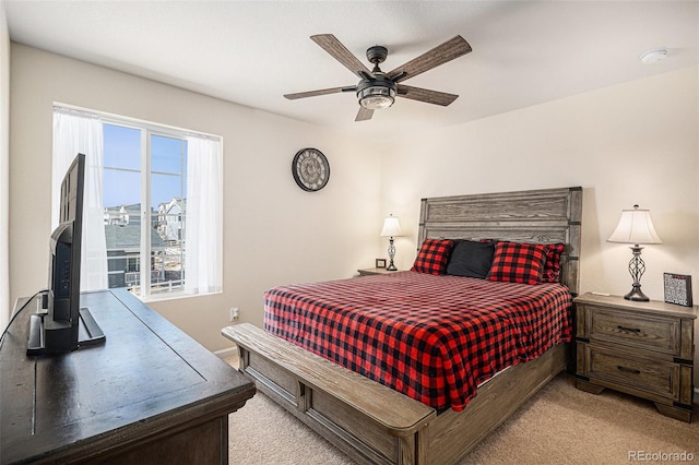 bedroom featuring light carpet and a ceiling fan
