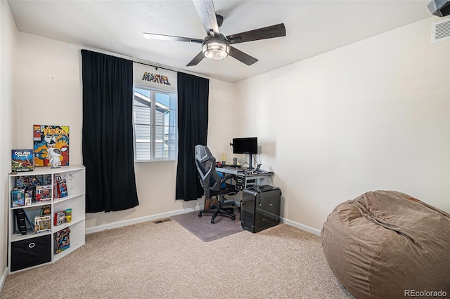 office space with baseboards, a ceiling fan, carpet, and visible vents