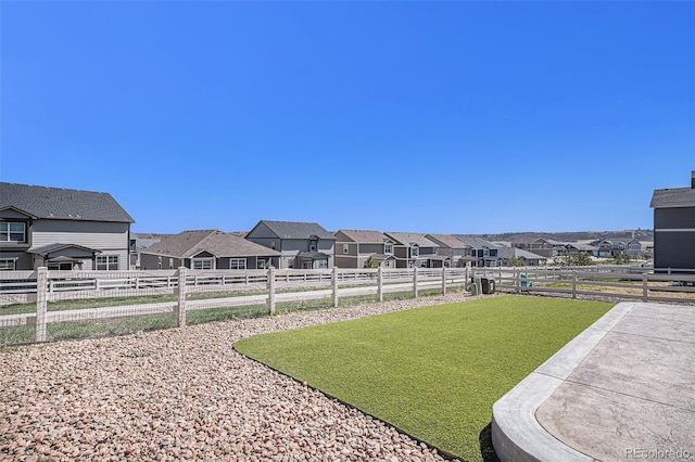 view of yard with fence and a residential view