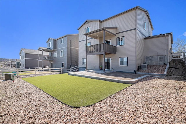back of property featuring a residential view, a fenced backyard, cooling unit, a balcony, and a patio