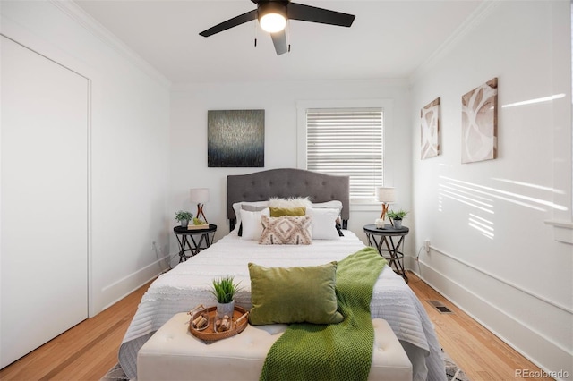 bedroom with crown molding, ceiling fan, and hardwood / wood-style floors