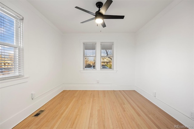 unfurnished room with crown molding, ceiling fan, and wood-type flooring