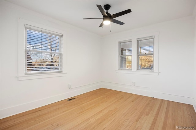 empty room featuring wood-type flooring, ornamental molding, and ceiling fan