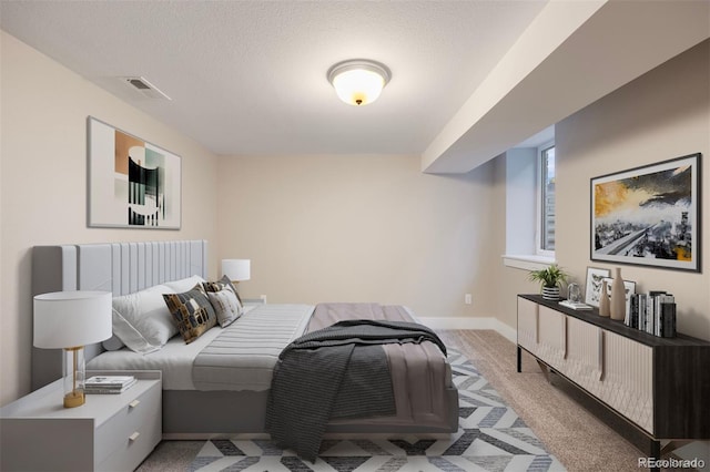 carpeted bedroom featuring a textured ceiling