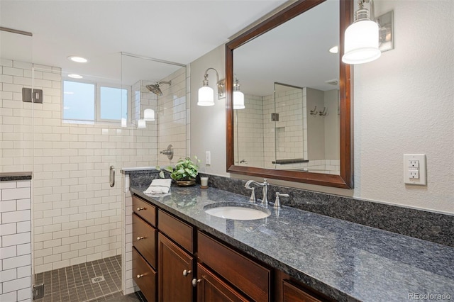 bathroom with vanity and a shower with door