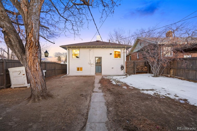 view of back house at dusk