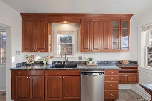 kitchen featuring a sink, glass insert cabinets, dishwasher, and dark stone counters