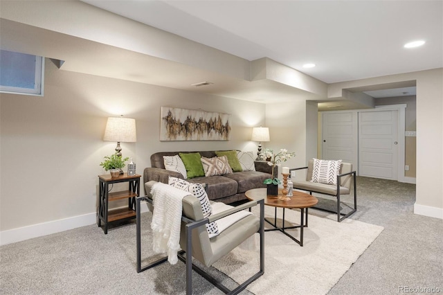 living area featuring recessed lighting, visible vents, baseboards, and light colored carpet