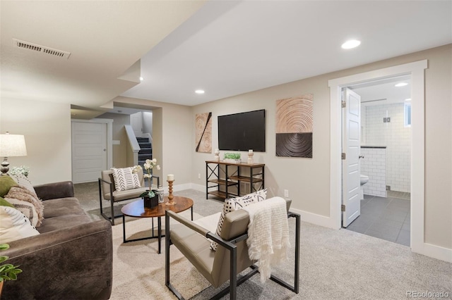 carpeted living area featuring stairs, recessed lighting, visible vents, and baseboards