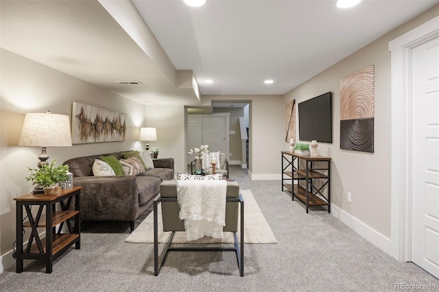 carpeted living area with visible vents, recessed lighting, and baseboards