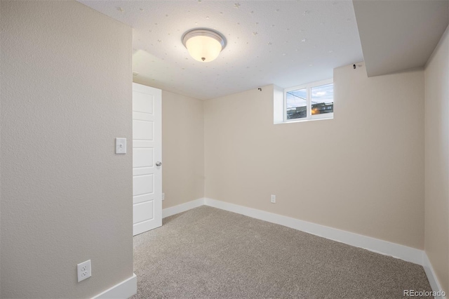 basement featuring carpet flooring and baseboards