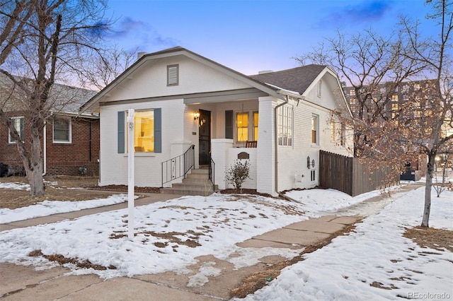 bungalow featuring fence and brick siding