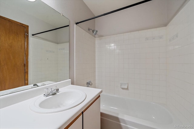 bathroom featuring tiled shower / bath combo and vanity