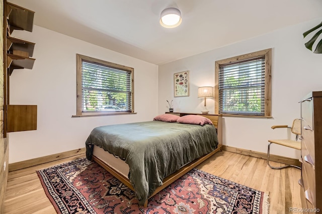 2844 Bellaire St, Denver, CO 80207 - bedroom featuring multiple windows, baseboards, and light wood-style flooring