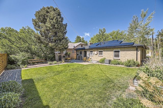 2844 Bellaire St, Denver, CO 80207 - rear view of property featuring a patio, solar panels, brick siding, and central AC unit