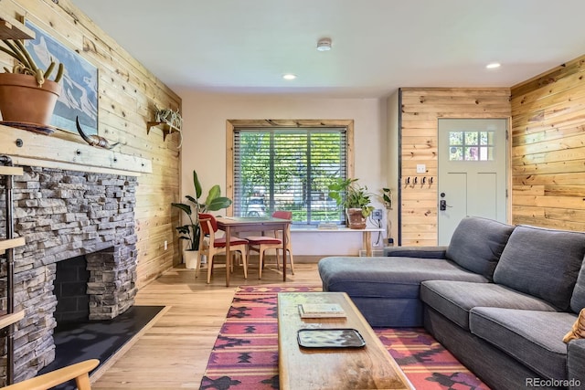 2844 Bellaire St, Denver, CO 80207 - living area with wooden walls, a stone fireplace, wood finished floors, and recessed lighting