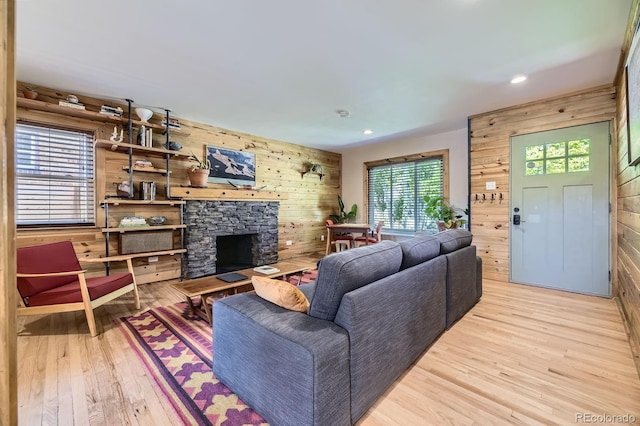 2844 Bellaire St, Denver, CO 80207 - living room with wooden walls, wood finished floors, a stone fireplace, and recessed lighting