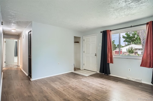 5274 Alkire St, Arvada, CO 80002 - empty room featuring a textured ceiling, wood finished floors, and attic access