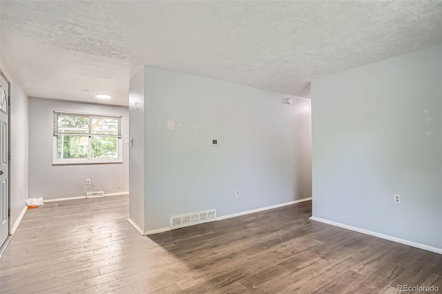 5274 Alkire St, Arvada, CO 80002 - spare room featuring a textured ceiling and hardwood / wood-style flooring