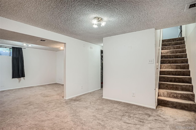 5274 Alkire St, Arvada, CO 80002 - finished basement featuring a textured ceiling, carpet, and stairs