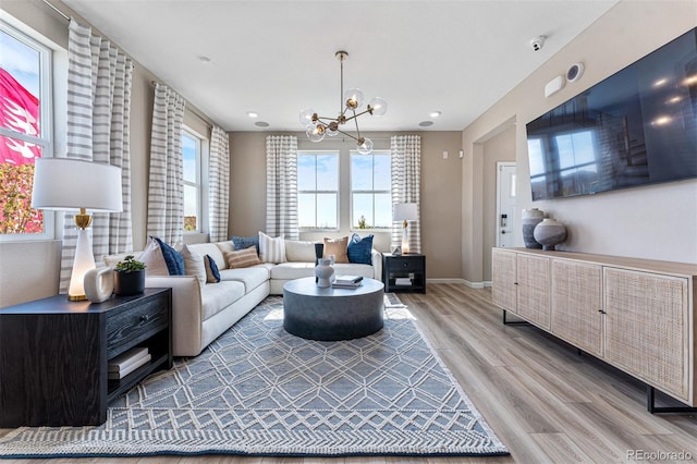 23782 E 33rd Pl, Aurora, CO 80019 - living area featuring light wood-style floors, a chandelier, baseboards, and recessed lighting