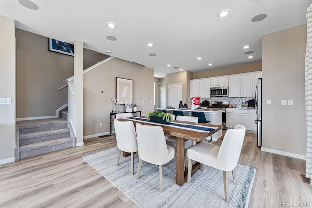 23782 E 33rd Pl, Aurora, CO 80019 - dining space featuring light wood-style floors, baseboards, stairs, and recessed lighting