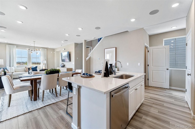 23782 E 33rd Pl, Aurora, CO 80019 - kitchen with dishwasher, a sink, light wood finished floors, open floor plan, and recessed lighting