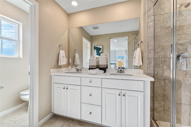 23782 E 33rd Pl, Aurora, CO 80019 - full bath featuring double vanity, a shower stall, toilet, and baseboards