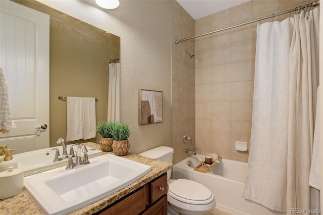 full bathroom featuring toilet, shower / bath combo, vanity, and a textured wall