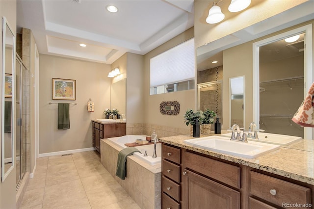 bathroom featuring a bath, a raised ceiling, a sink, a shower stall, and tile patterned flooring