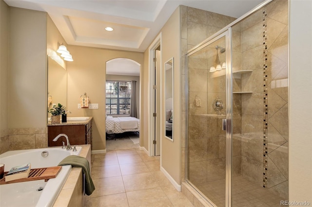 ensuite bathroom featuring ensuite bathroom, a shower stall, vanity, tile patterned flooring, and a garden tub