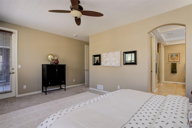 bedroom with access to outside, baseboards, light carpet, visible vents, and arched walkways