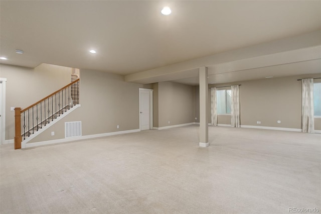 below grade area featuring light colored carpet, baseboards, visible vents, and recessed lighting
