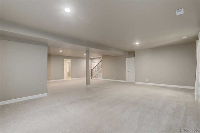 finished basement with light carpet, recessed lighting, baseboards, and stairway
