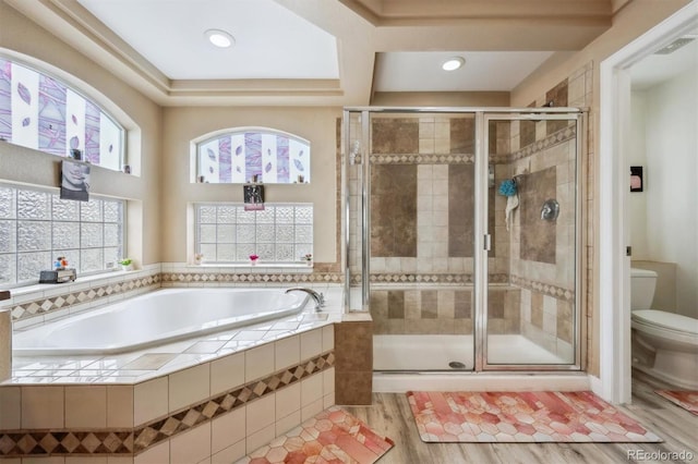 5293 Malaya St, Denver, CO 80249 - full bathroom with a stall shower, wood finished floors, a bath, and toilet