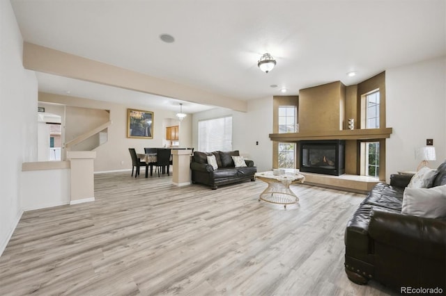 5293 Malaya St, Denver, CO 80249 - living room with recessed lighting, wood finished floors, a tiled fireplace, and baseboards