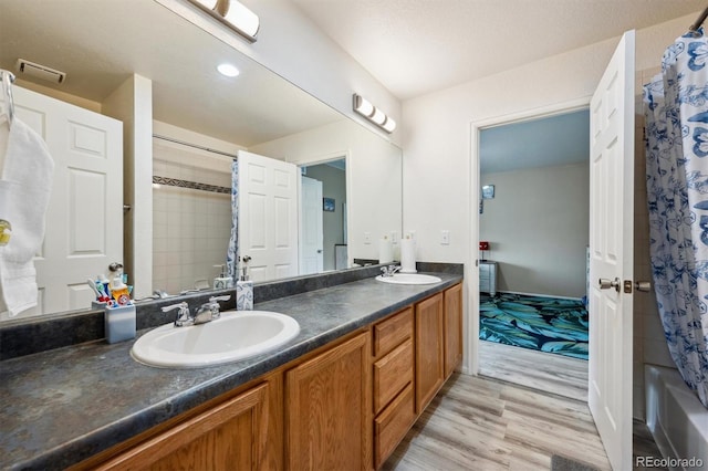 5293 Malaya St, Denver, CO 80249 - bathroom with wood finished floors, a sink, visible vents, and double vanity