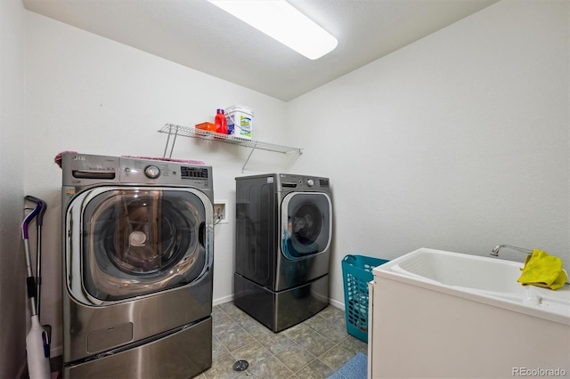 5293 Malaya St, Denver, CO 80249 - clothes washing area featuring washing machine and dryer, baseboards, and laundry area
