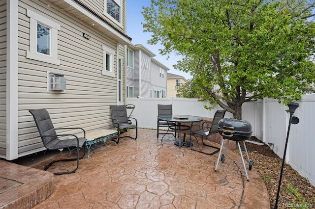 5293 Malaya St, Denver, CO 80249 - view of patio with a fenced backyard, area for grilling, and a wall unit AC