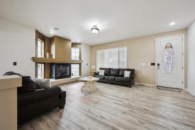 5293 Malaya St, Denver, CO 80249 - living room featuring baseboards, a tiled fireplace, wood finished floors, and recessed lighting