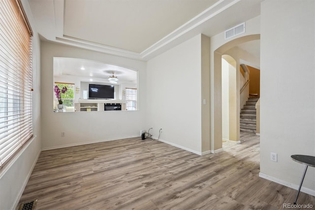 5293 Malaya St, Denver, CO 80249 - unfurnished living room with wood finished floors, a ceiling fan, visible vents, and arched walkways