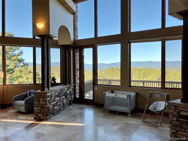 sunroom with a healthy amount of sunlight and a mountain view