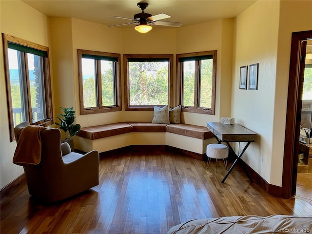 sitting room featuring ceiling fan, plenty of natural light, and hardwood / wood-style flooring