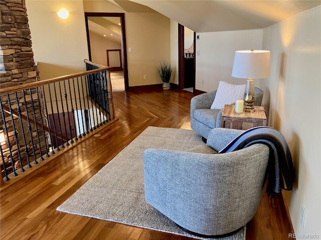 living room featuring dark wood-type flooring and vaulted ceiling