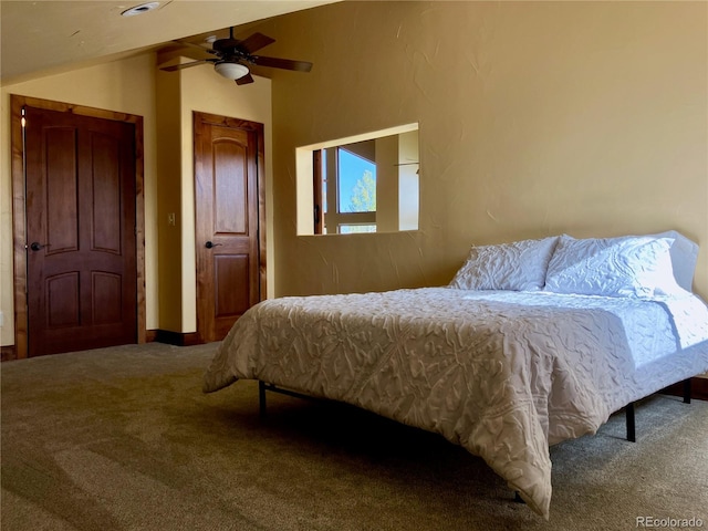 bedroom with vaulted ceiling, carpet, and ceiling fan