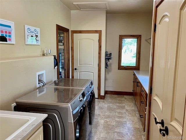 washroom with hookup for a washing machine, washer and clothes dryer, cabinets, and light tile floors