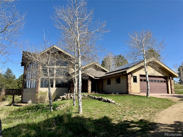 view of front of home with a front yard and a garage